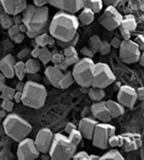 this is a scanning electron microscope image of a new material that self-assembles into polyhedra